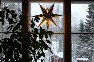Joulutähti ikkunassa ja luminen maisema